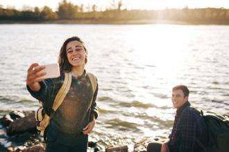 couple taking selfie at the lake