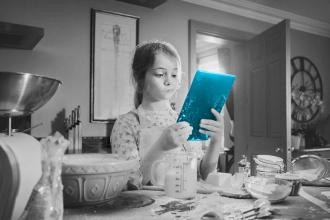 Girl baking with tablet