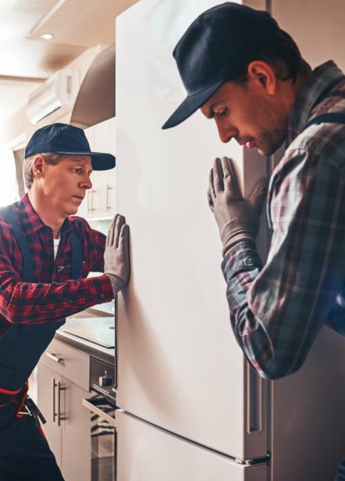 two repair men moving fridge
