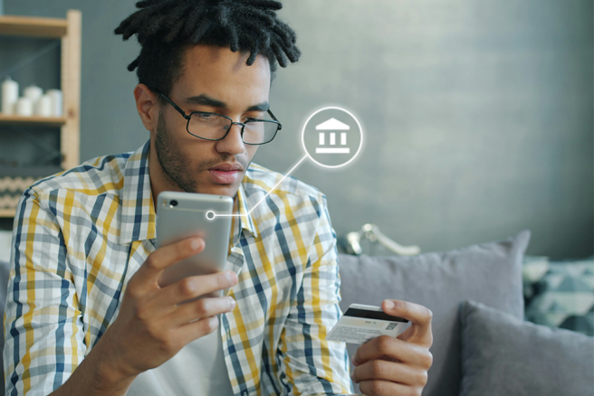 Man on phone with bank card